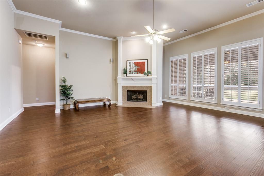 6027 Rathbone Drive Parker, TX 75002 - Photo 10 of 39 an empty room with fireplace wooden floor and windows