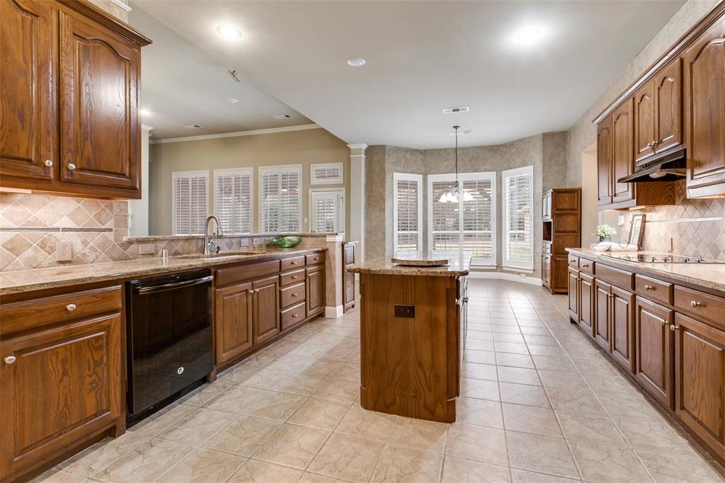 6027 Rathbone Drive Parker, TX 75002 - Photo 13 of 39 a large kitchen with stainless steel appliances granite countertop a stove top oven a sink dishwasher a dining table and chairs