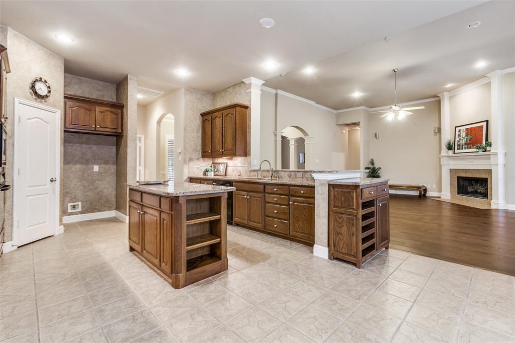 6027 Rathbone Drive Parker, TX 75002 - Photo 14 of 39 a kitchen with stainless steel appliances a sink and cabinets
