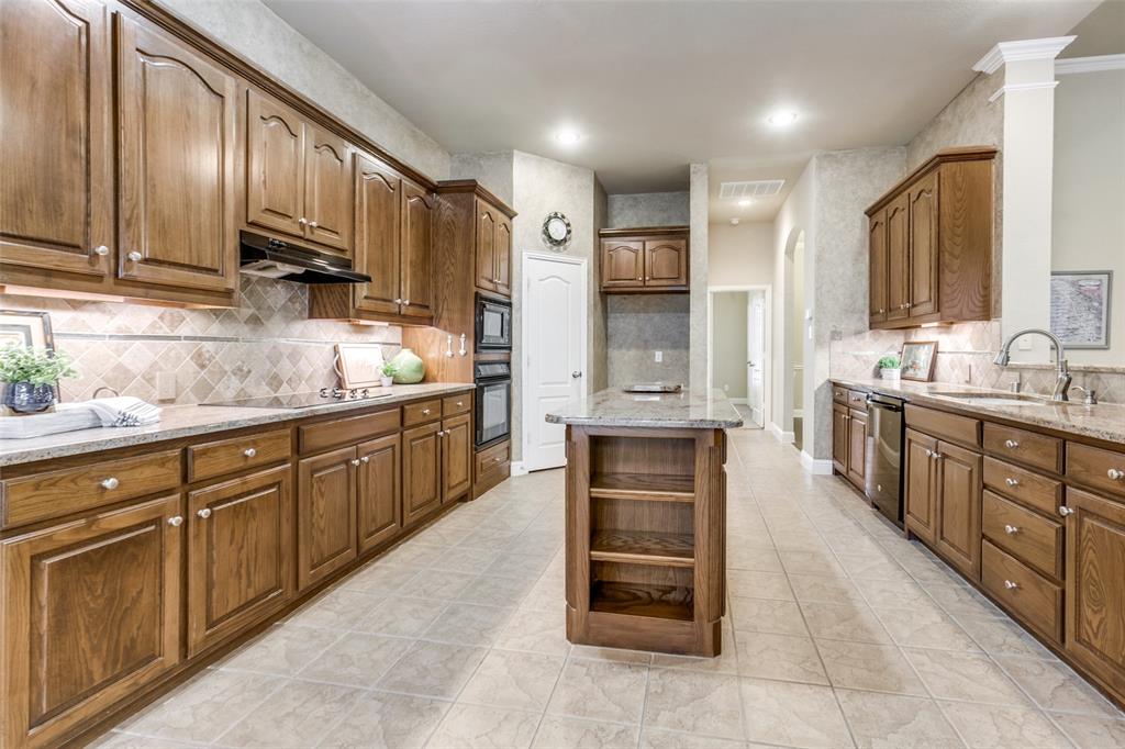6027 Rathbone Drive Parker, TX 75002 - Photo 15 of 39 a large kitchen with stainless steel appliances wooden cabinets and a sink