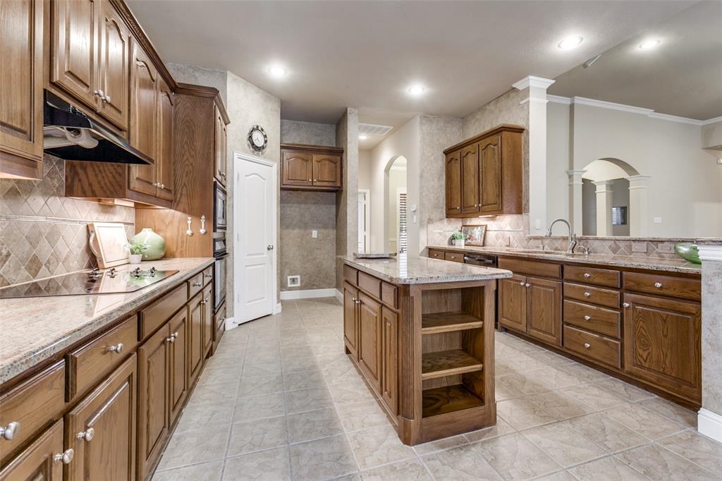 6027 Rathbone Drive Parker, TX 75002 - Photo 16 of 39 a large kitchen with a large counter top and sink