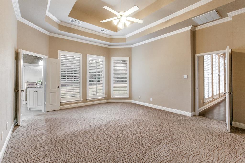 6027 Rathbone Drive Parker, TX 75002 - Photo 18 of 39 The primary bedroom is located in the back of the home just off the family room with a lot of space and plenty of natural light.