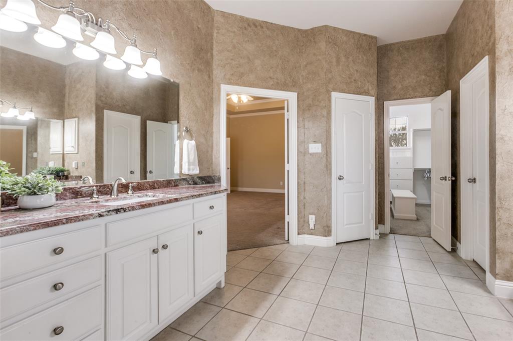 6027 Rathbone Drive Parker, TX 75002 - Photo 20 of 39 a bathroom with a double vanity sink and a mirror