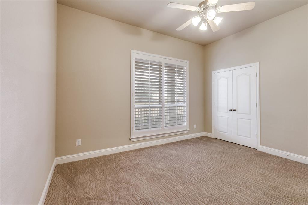 6027 Rathbone Drive Parker, TX 75002 - Photo 22 of 39 an empty room with chandelier fan and windows