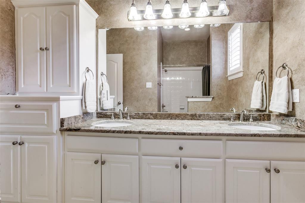 6027 Rathbone Drive Parker, TX 75002 - Photo 26 of 39 Another secondary bathroom. This one with a double vanity, tons of storage and cabinets, and a shower/tub combo.