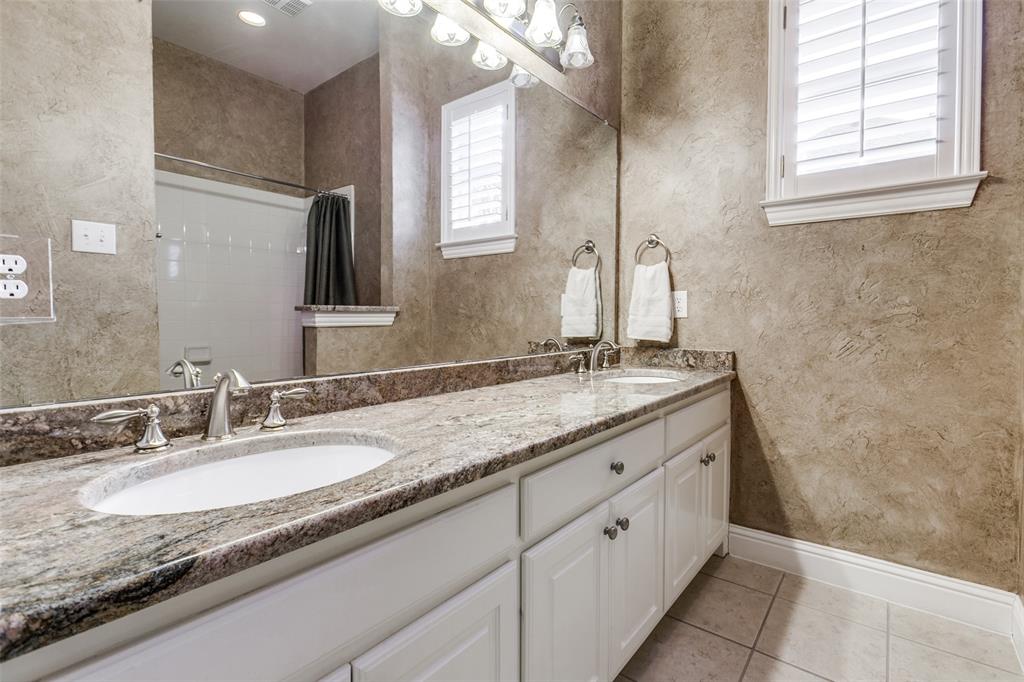 6027 Rathbone Drive Parker, TX 75002 - Photo 27 of 39 a bathroom with a granite countertop sink a mirror and a bathtub