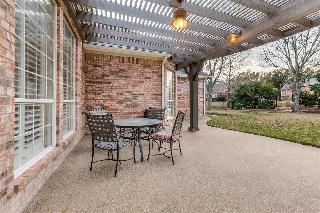 6027 Rathbone Drive Parker, TX 75002 - Photo 28 of 39 a view of a patio with a table and chairs next to a yard