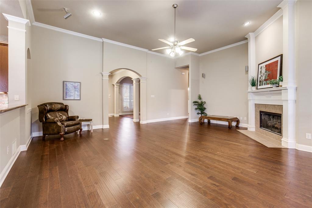 6027 Rathbone Drive Parker, TX 75002 - Photo 9 of 39 a view of a livingroom with furniture a fireplace wooden floor and a window