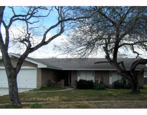 a view of house with a yard