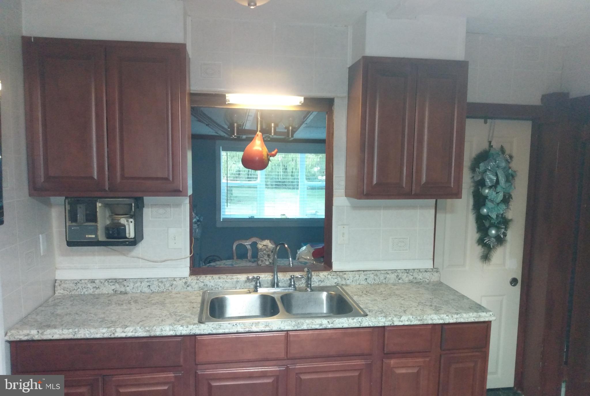 2175 Telegraph Road Rising Sun, MD 21911 - Photo 4 of 14 a kitchen with granite countertop a sink a stove and cabinets