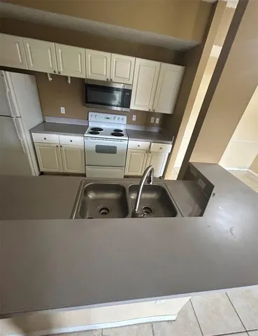 a refrigerator freezer sitting inside of a kitchen
