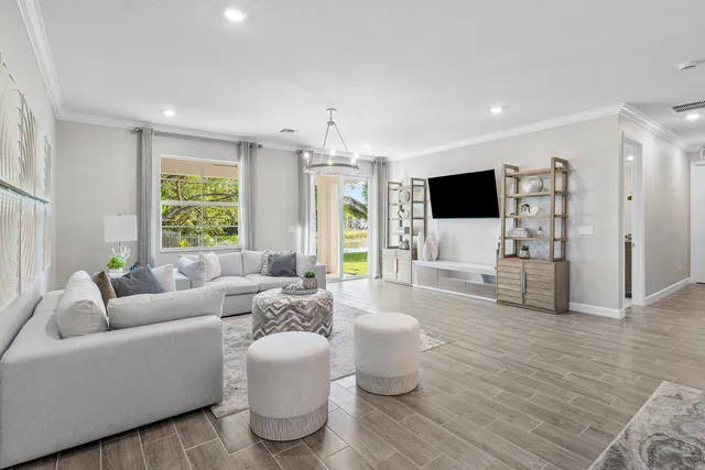 a living room with furniture a flat screen tv and a large window