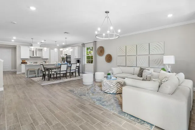 a living room with furniture and kitchen view