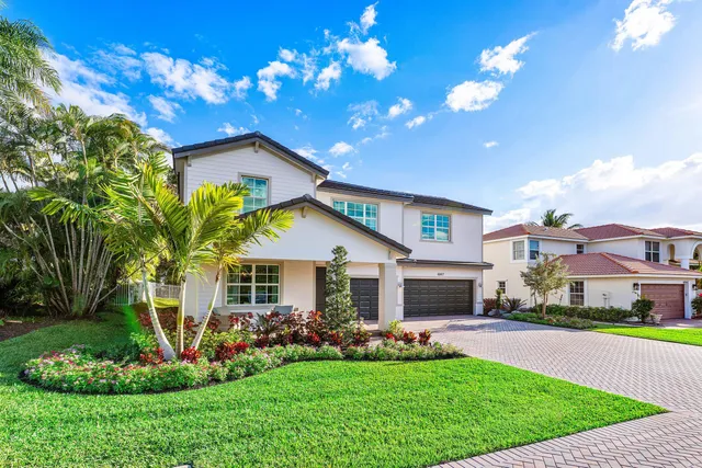 a front view of a house with a garden and plants