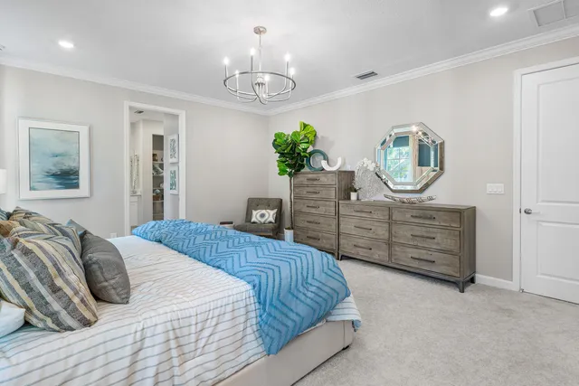 a bedroom with a bed and painting on the wall