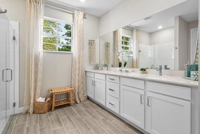 a spacious bathroom with a double vanity sink and a mirror