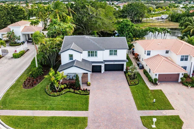 an aerial view of a house with a yard table and chairs