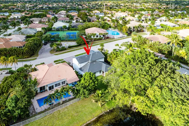 an aerial view of a house a yard and swimming pool