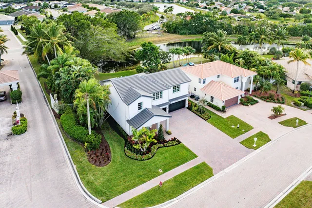 an aerial view of a house with swimming pool patio and outdoor seating