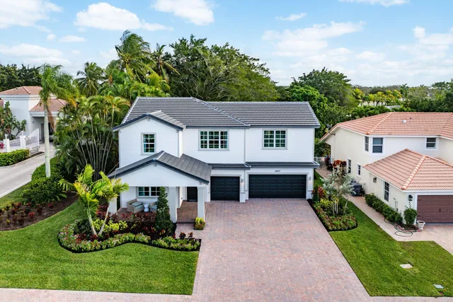 a aerial view of a house with a yard and potted plants