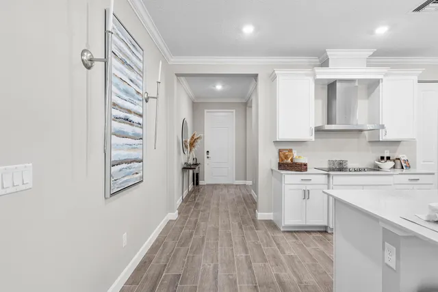 a kitchen with cabinets and wooden floor