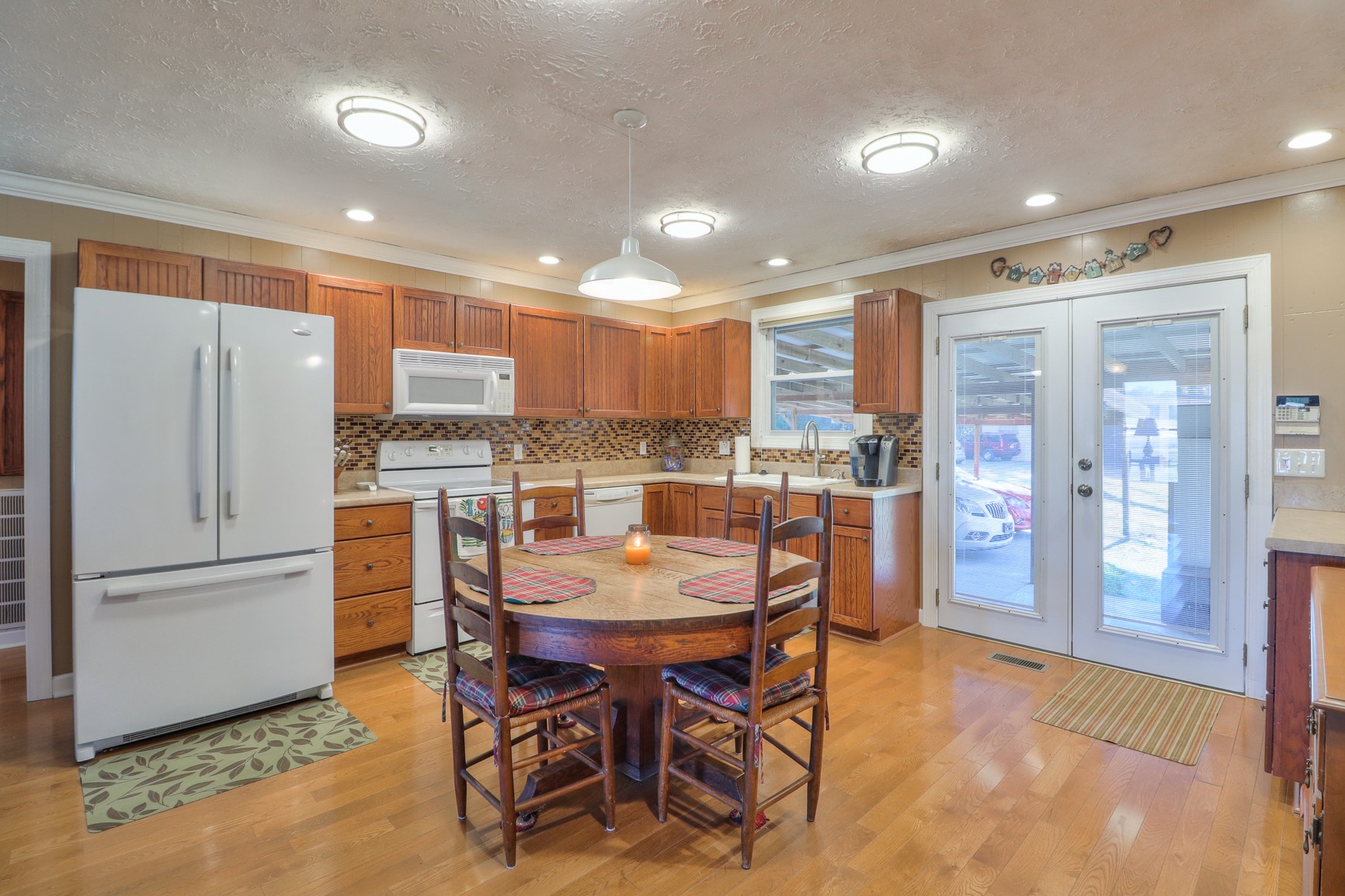 1824 Logue Road Mount Juliet, TN 37122 - Photo 9 of 53 a kitchen with a refrigerator a dining table and chairs