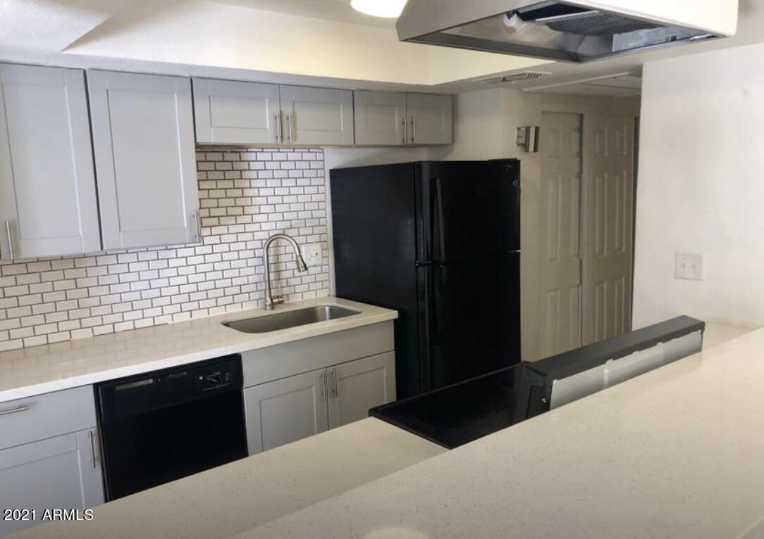 a kitchen with a sink and a refrigerator