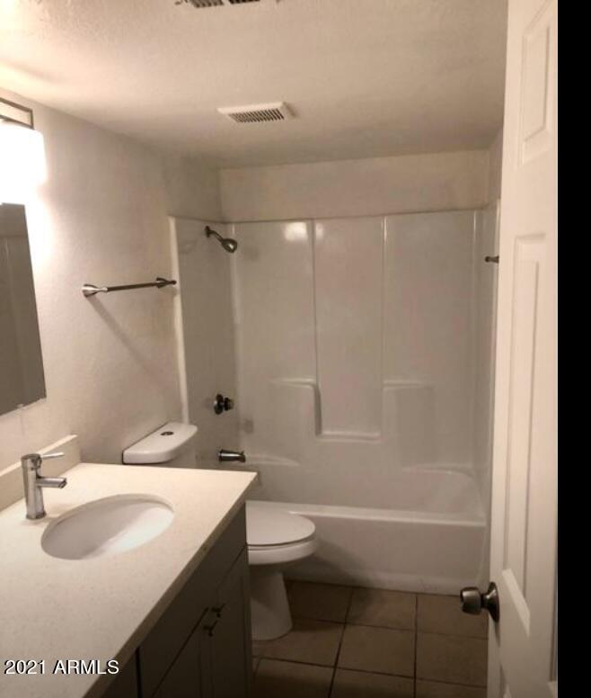 18202 North Cave Creek Road, Unit 117 Phoenix, AZ 85032 - Photo 4 of 6 a bathroom with a sink toilet tub and shower