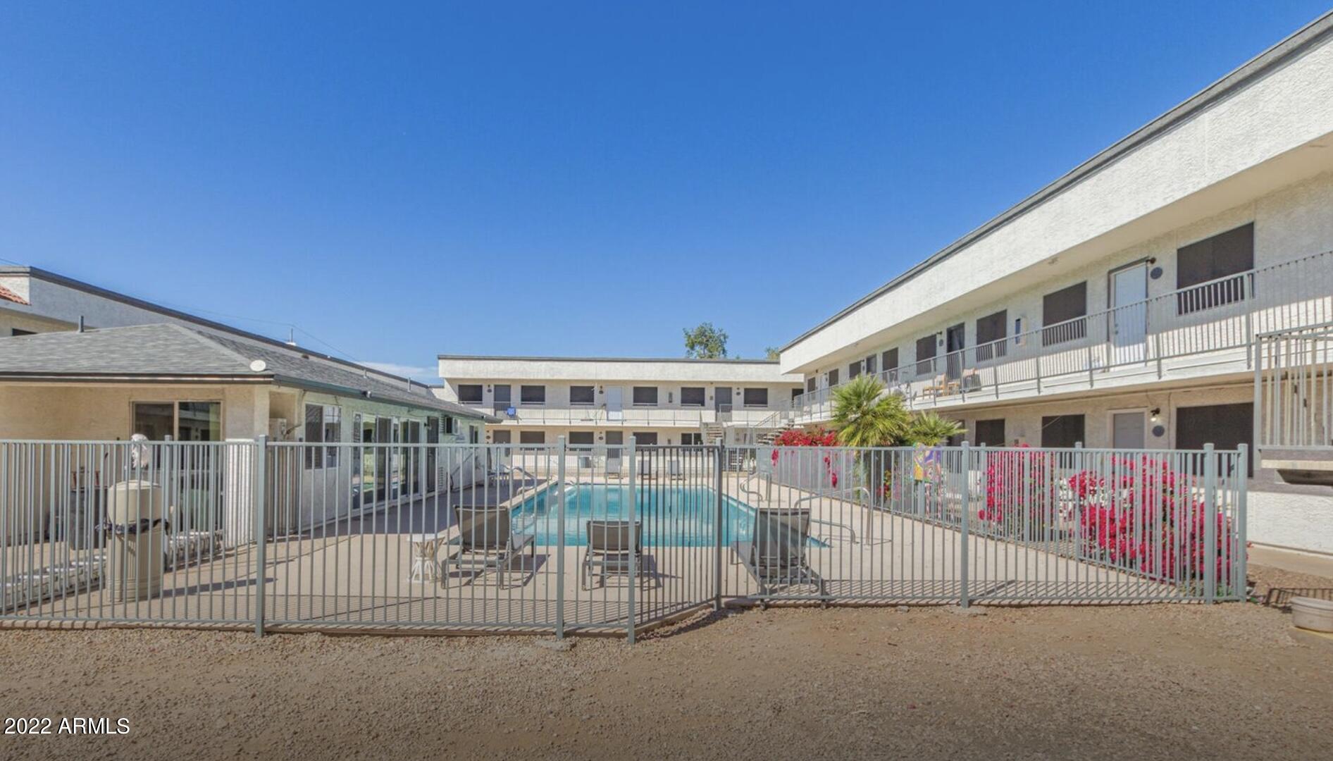 18202 North Cave Creek Road, Unit 117 Phoenix, AZ 85032 - Photo 6 of 6 a view of a building with a outdoor space