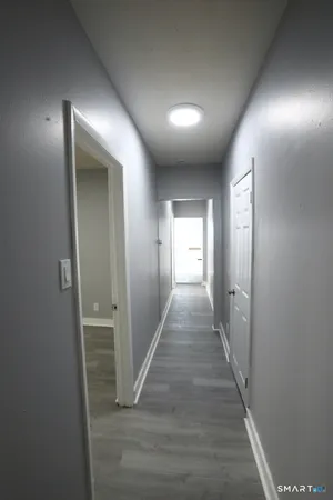 an entryway door with wooden floor