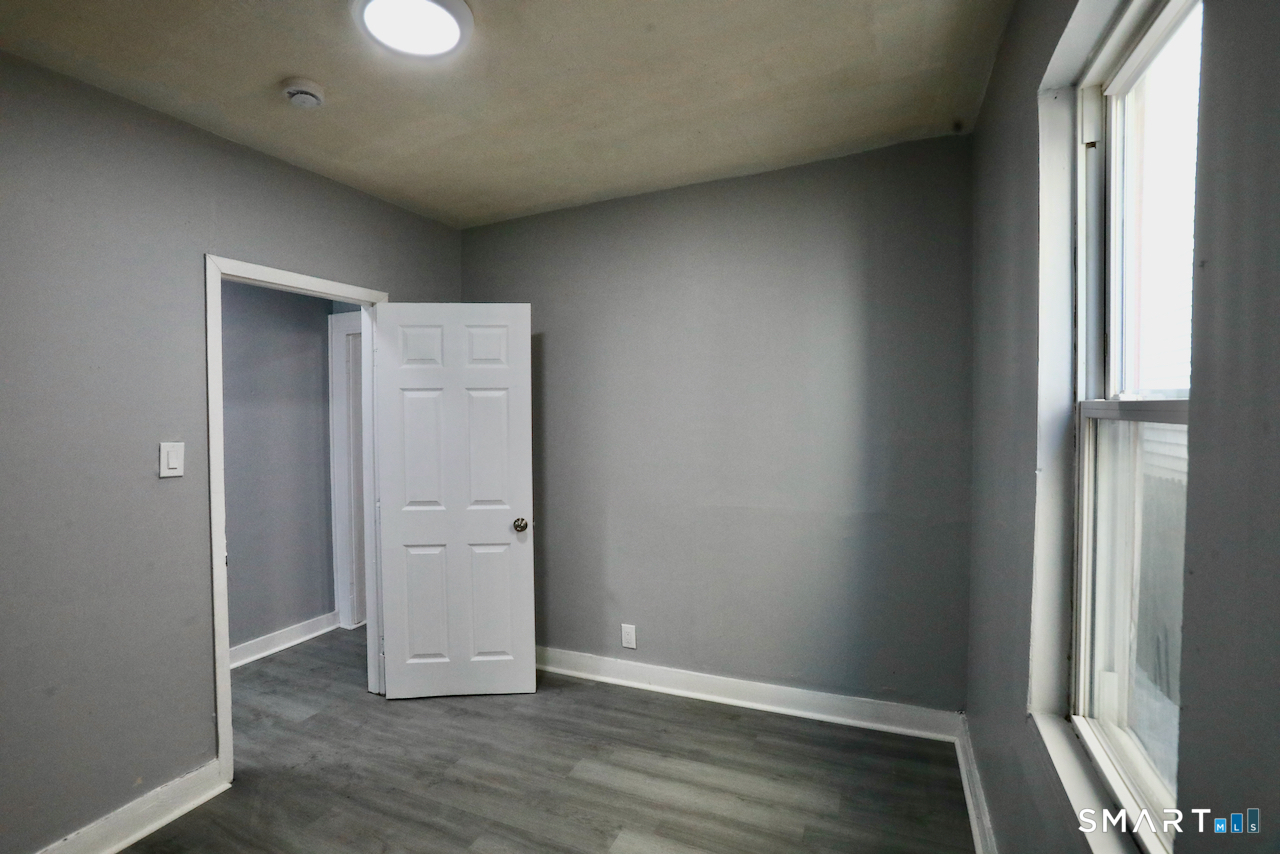 156 Poplar Street, Unit 1 New Haven, CT 06513 - Photo 15 of 31 an empty room with wooden floor and closet
