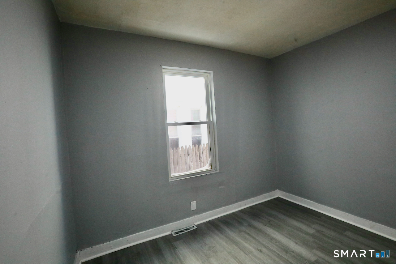 156 Poplar Street, Unit 1 New Haven, CT 06513 - Photo 17 of 31 wooden floor and window in an empty room