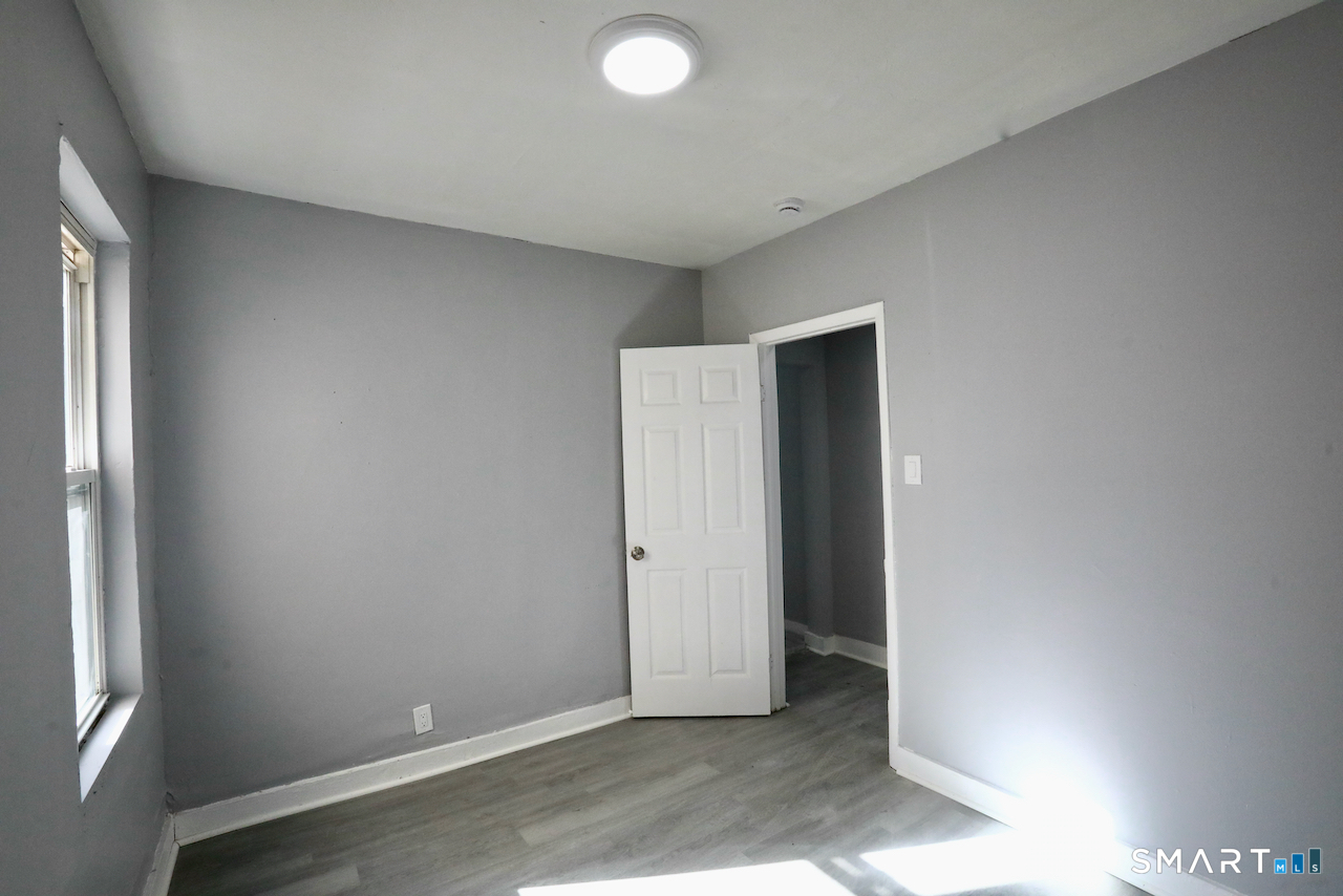 156 Poplar Street, Unit 1 New Haven, CT 06513 - Photo 21 of 31 an empty room with windows