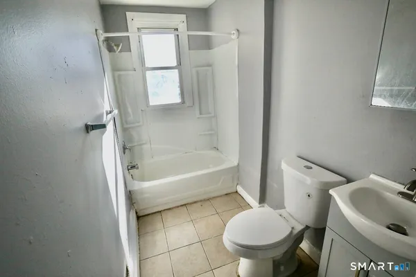 a bathroom with a toilet and a bathtub