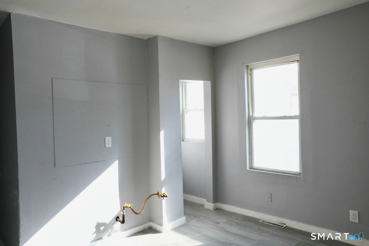 156 Poplar Street, Unit 1 New Haven, CT 06513 - Photo 26 of 31 a bathroom with a window sink and vanity