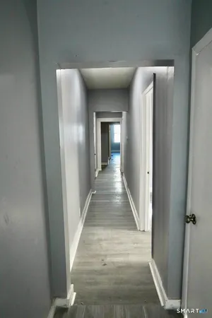 a view of gallery with wooden floor