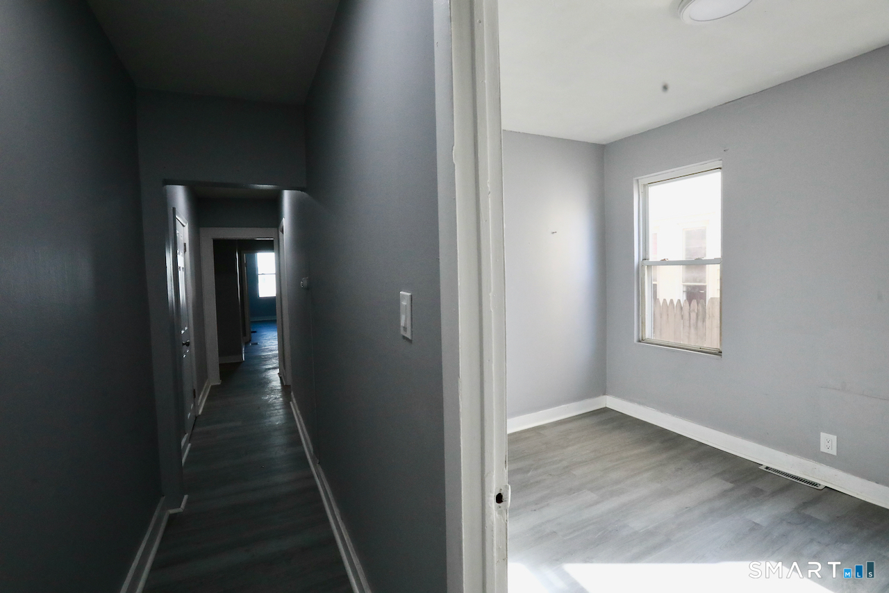 156 Poplar Street, Unit 1 New Haven, CT 06513 - Photo 31 of 31 a view of a hallway with wooden floor and closet