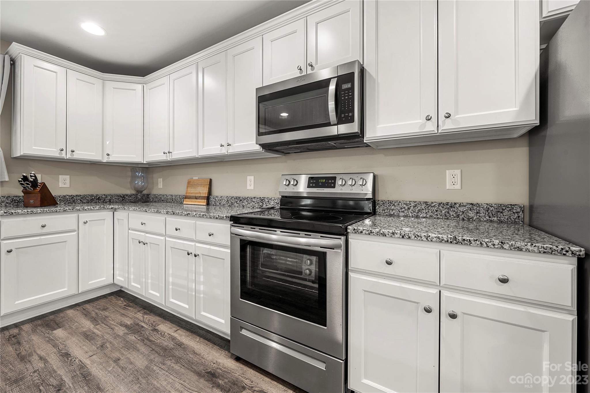 2000 Stirewalt Road China Grove, NC 28023 - Photo 14 of 43 a kitchen with granite countertop white cabinets and appliances