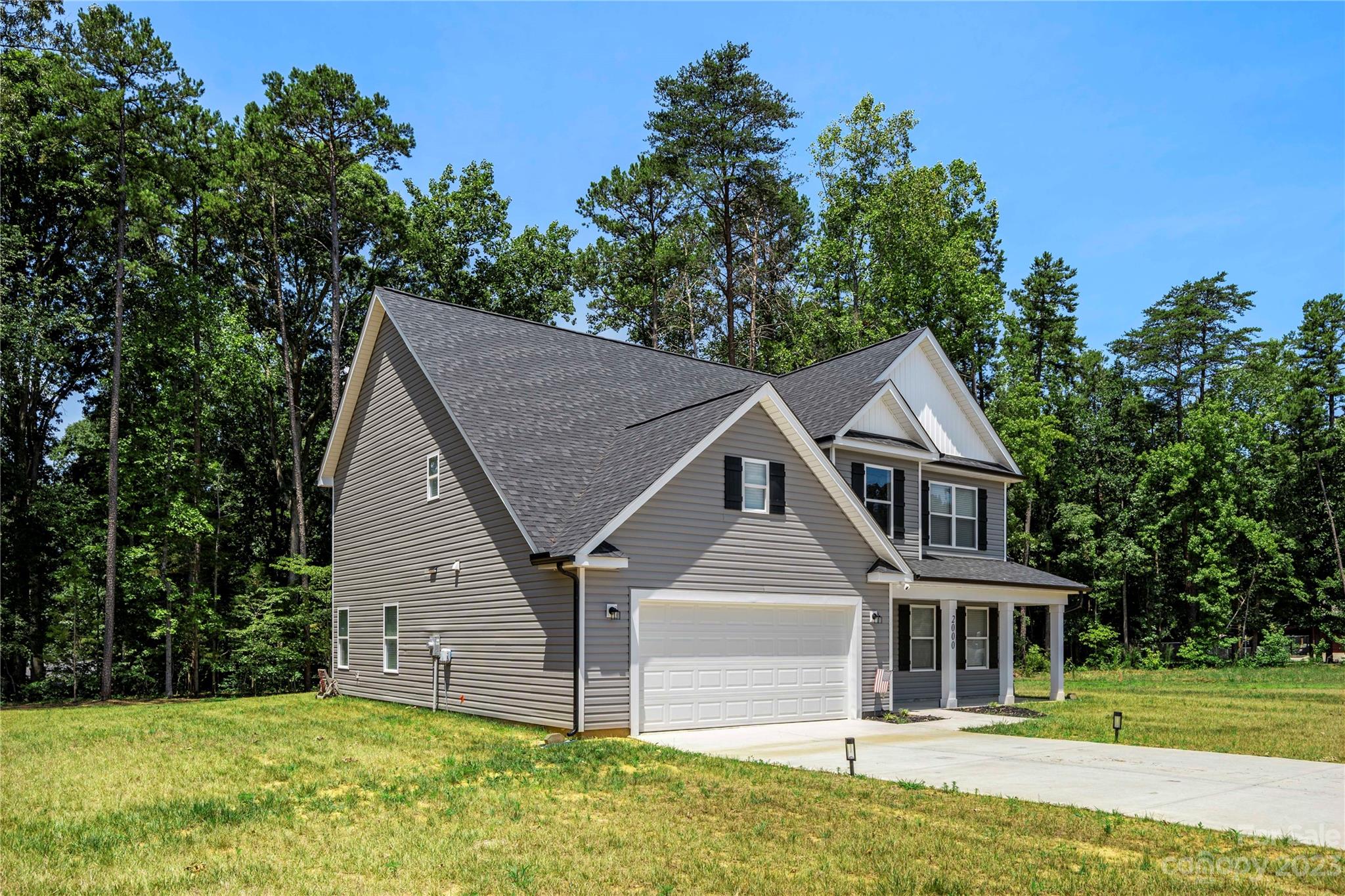 2000 Stirewalt Road China Grove, NC 28023 - Photo 4 of 43 a front view of a house with a garden