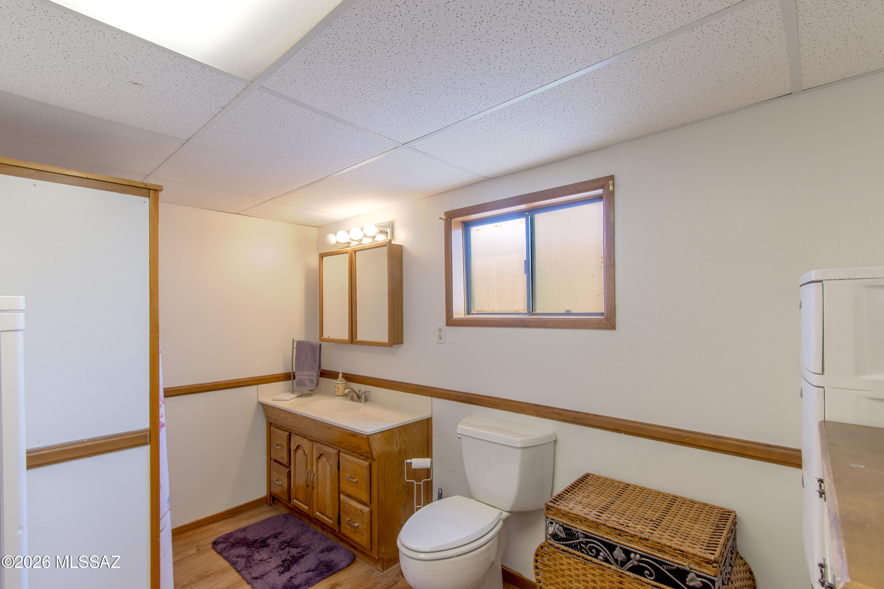 4550 North Flowing Wells Road, Unit 155 Tucson, AZ 85705 - Photo 20 of 40 a bathroom with a toilet a sink and mirror