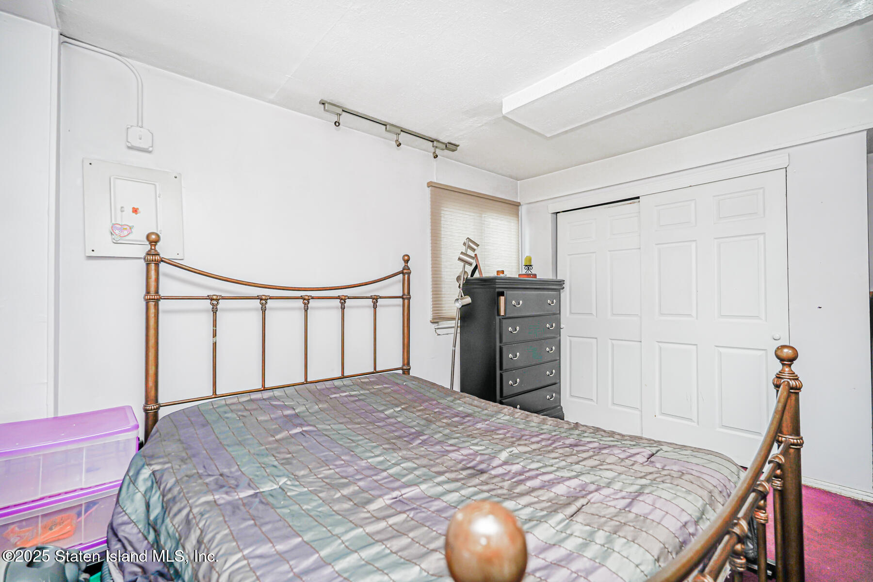 443 Ridgewood Avenue Staten Island, NY 10312 - Photo 15 of 26 a bedroom with a bed and a dresser