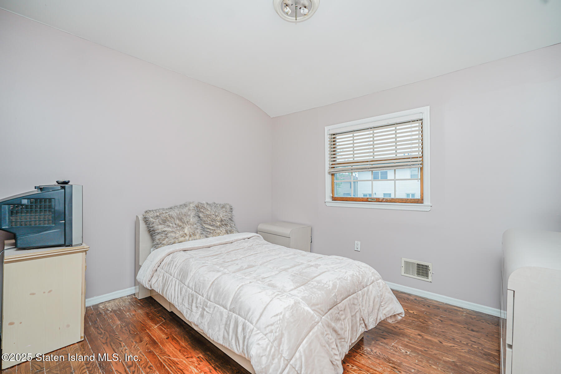 443 Ridgewood Avenue Staten Island, NY 10312 - Photo 17 of 26 a bedroom with a bed and wooden floor