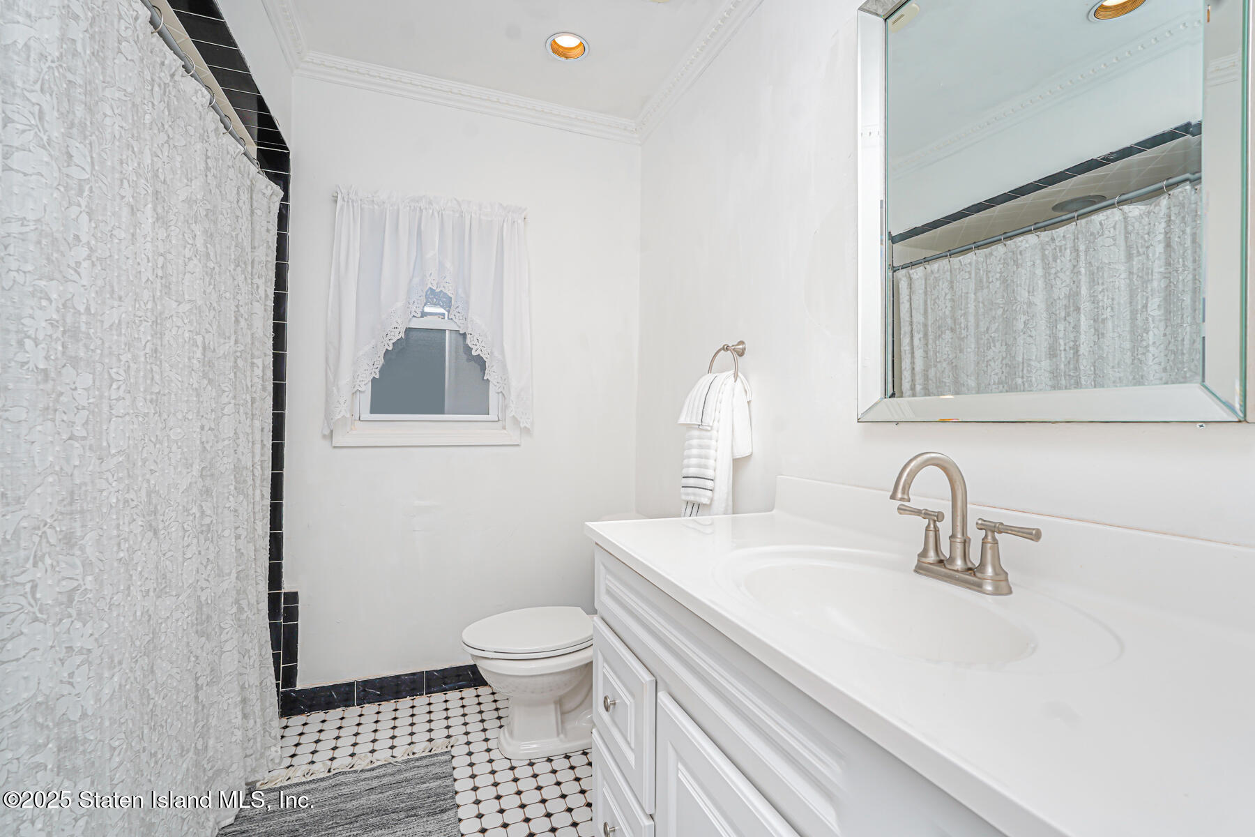 443 Ridgewood Avenue Staten Island, NY 10312 - Photo 19 of 26 a bathroom with a sink toilet and shower