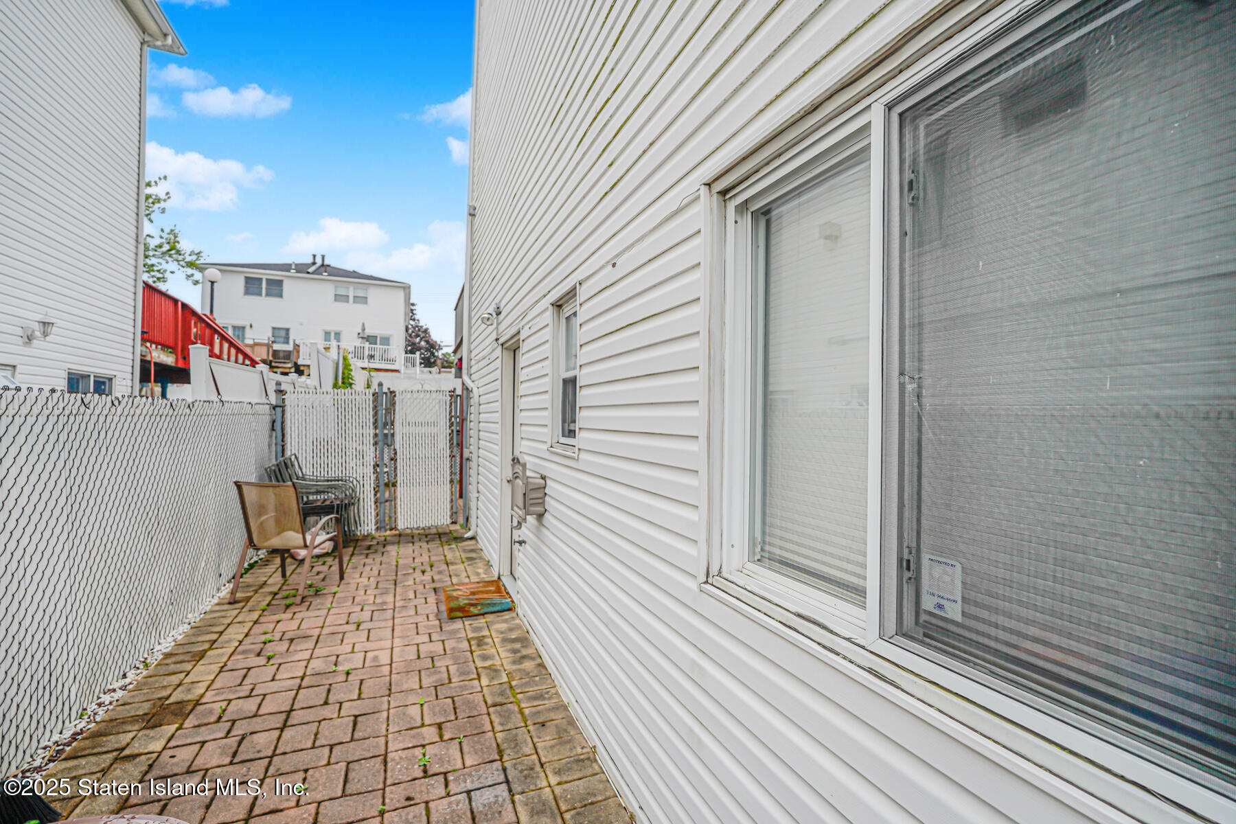 443 Ridgewood Avenue Staten Island, NY 10312 - Photo 24 of 26 a view of a balcony with chair and front door