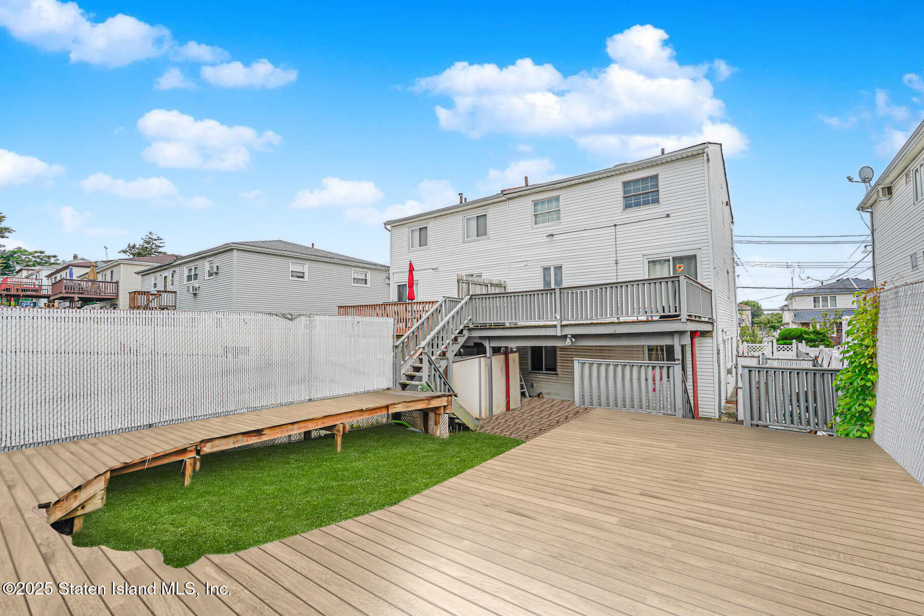 443 Ridgewood Avenue Staten Island, NY 10312 - Photo 25 of 26 a view of a house with a barbeque and wooden floor