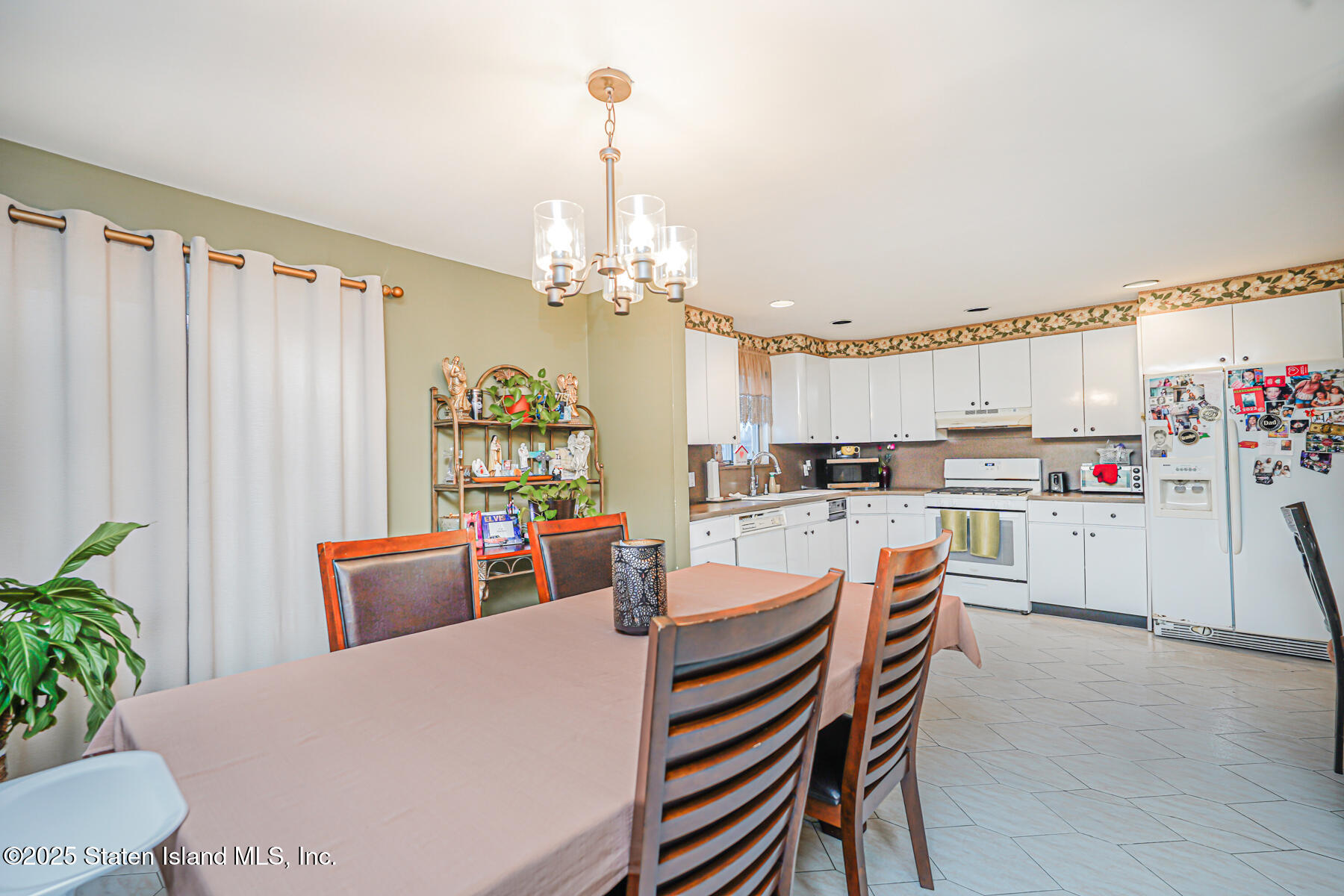 443 Ridgewood Avenue Staten Island, NY 10312 - Photo 8 of 26 a very nice looking dining room with kitchen island furniture a chandelier and a view of kitchen