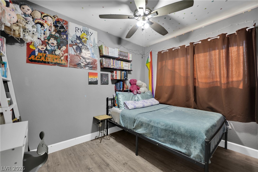 2221 Englestad Street North Las Vegas, NV 89030 - Photo 24 of 32 Laminate flooring and a ceiling fan create a comfortable atmosphere in this sleeping space.