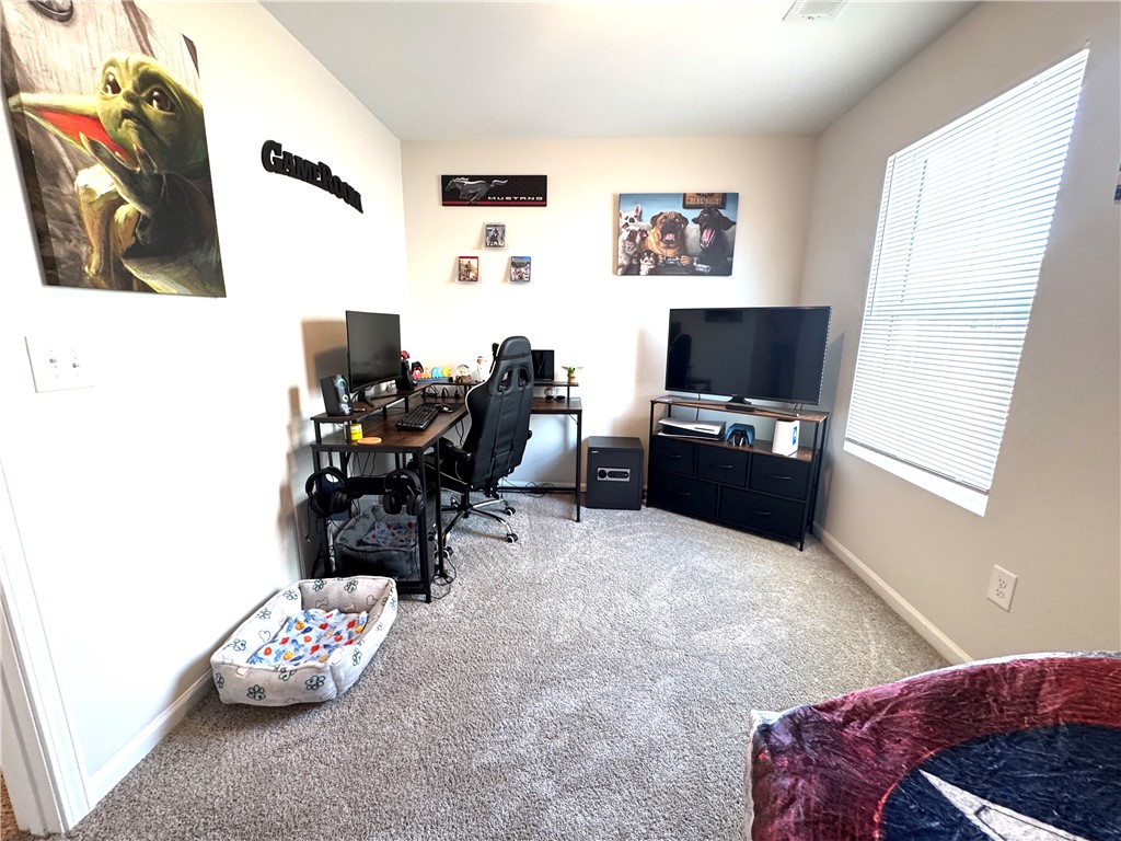 143 Adger Road Pendleton, SC 29670 - Photo 29 of 30 Plush wall-to-wall carpeting and a wide window create a comfortable secondary bedroom setup.