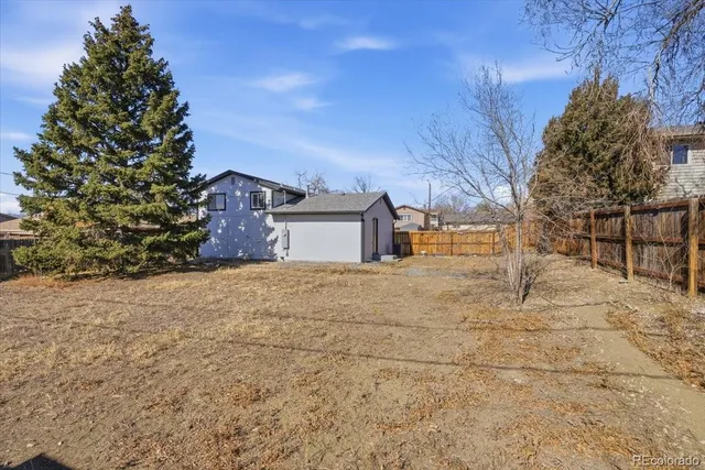 a view of a house with a yard and garage