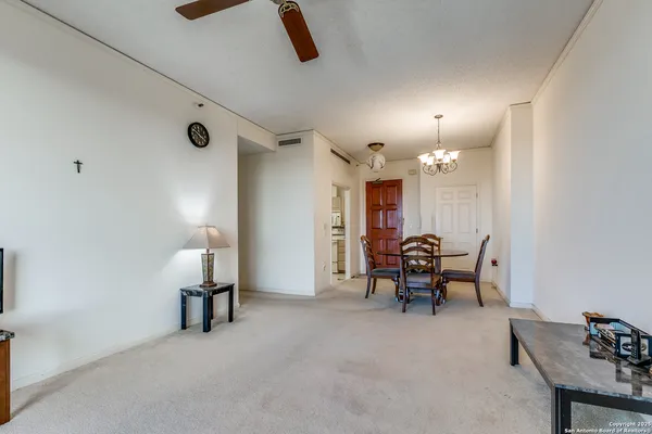 a view of a livingroom with furniture and a kitchen